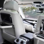 White Rolls-Royce Ghost II interior with drop down tables and TV screens