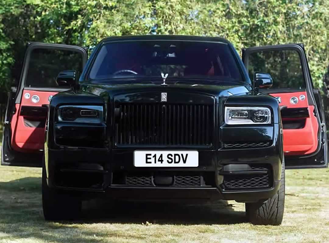 Black Rolls-Royce Cullinan rear coach doors open show red interior