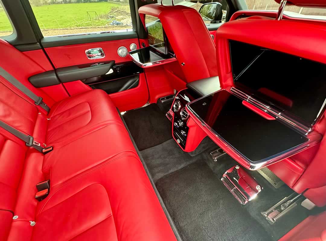 Black Rolls-Royce Cullinan red interior rear seating and drop down TV screens