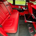 Black Rolls-Royce Cullinan interior rear red leather seating