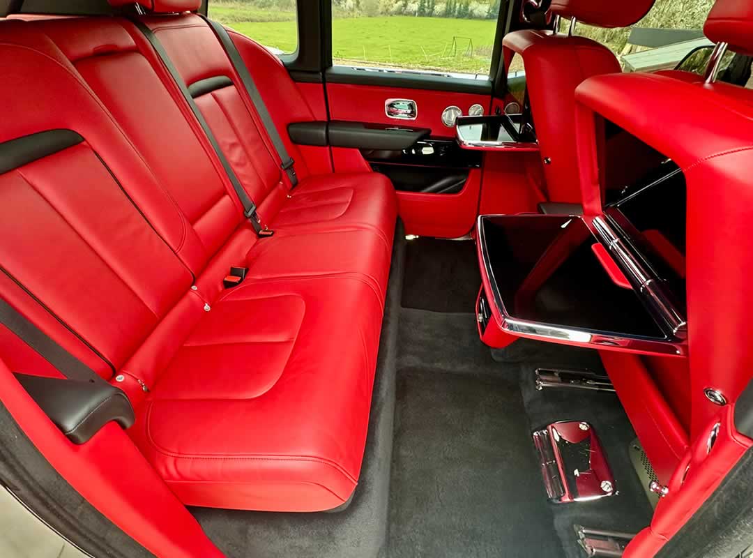 Black Rolls-Royce Cullinan interior rear red leather seating