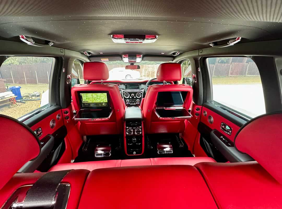 Black Rolls-Royce Cullinan red interior rear view to front seats