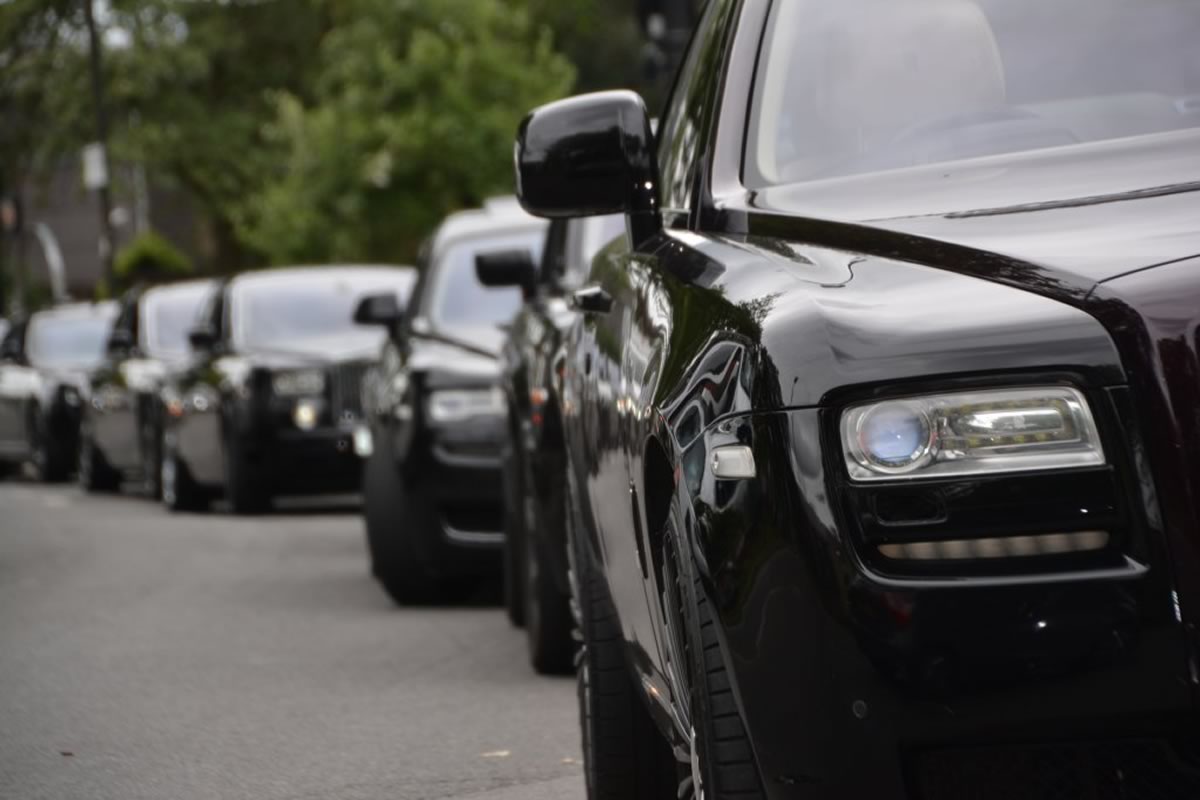 Black Rolls-Royce limousines lined up at a funeral