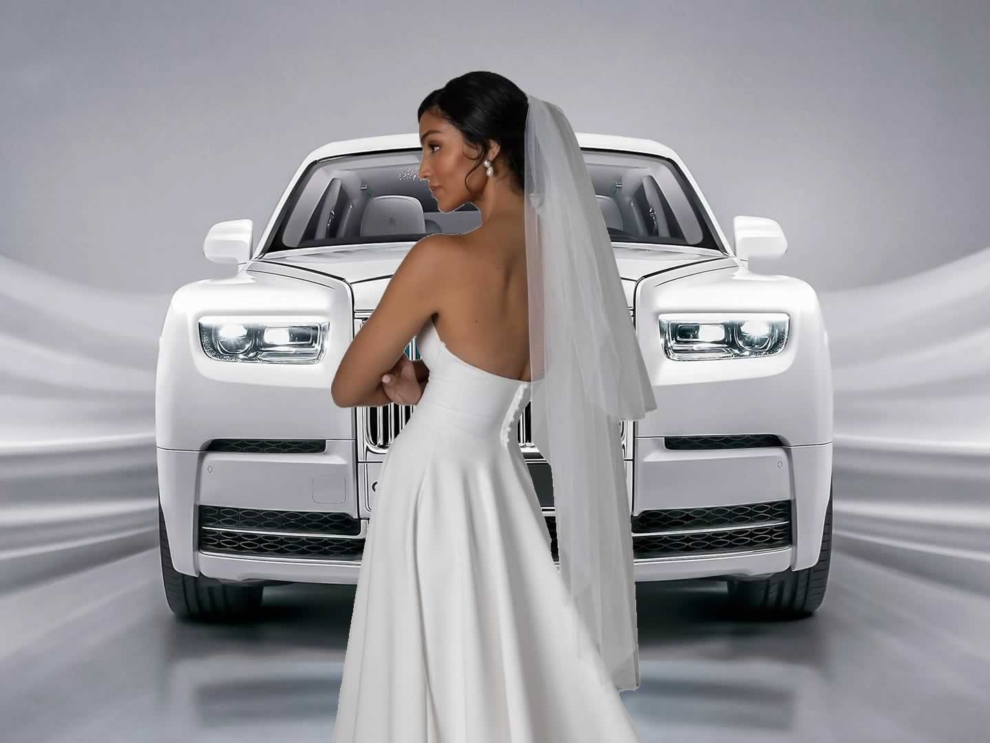 Bride in a white wedding gown in front of a white Rolls-Royce